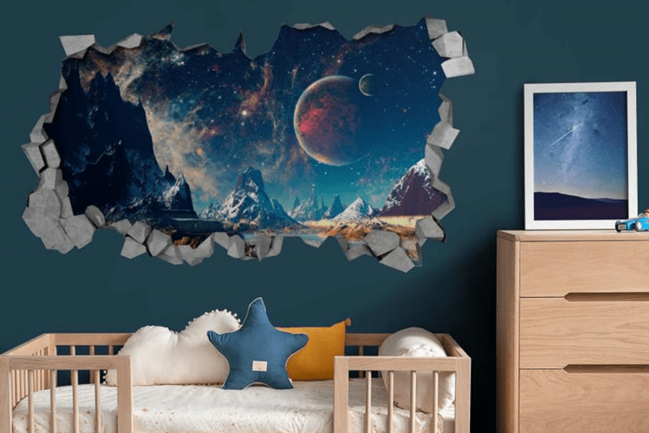 Kids bedroom with a deep teal wall featuring a bold 3D style space mural that looks like a cracked opening to a galaxy with planets and mountains above a light wood crib and dresser.