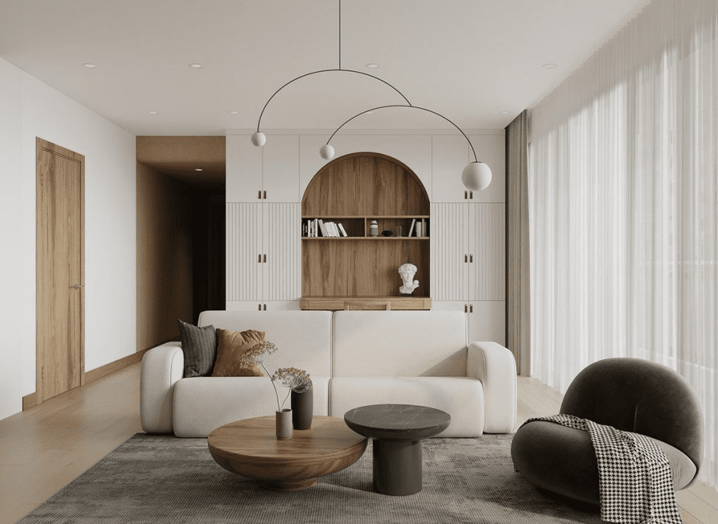 Minimalist living room with a curved white sofa, spherical arc pendant lights, and a built in arched wood niche that creates a portal like focal point.