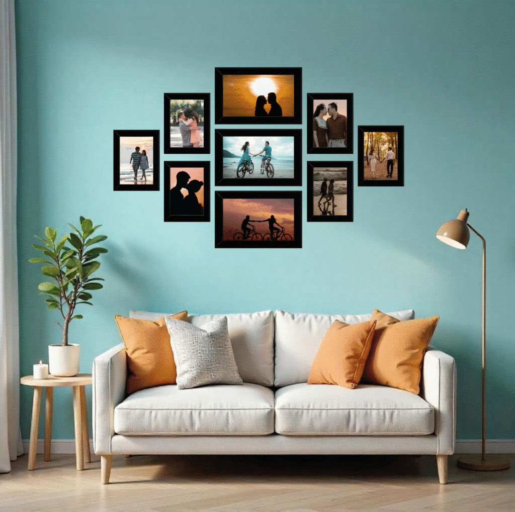 Teal accent wall above a light gray sofa with tan pillows, featuring a curated gallery wall of black frames filled with couple photos, with a potted plant on a side table and a floor lamp nearby.
