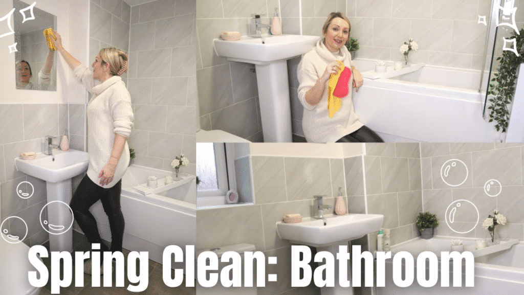 Woman spring cleaning a light gray tiled bathroom, wiping the mirror, sink, and tub to create a tidy spa like space.