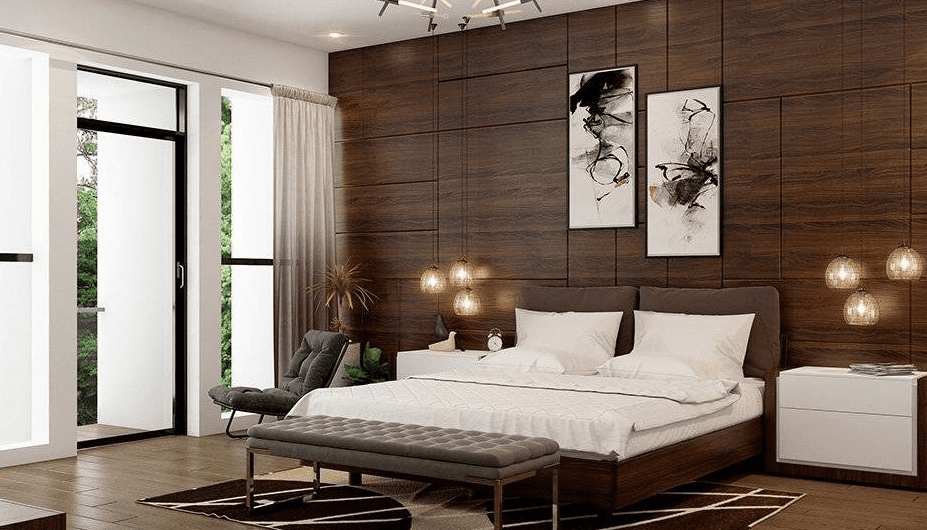 Contemporary bedroom with dark wood paneled wall, low dark wood bed frame with white bedding, tufted gray bench, hanging glass pendant lights, and tall windows bringing in daylight