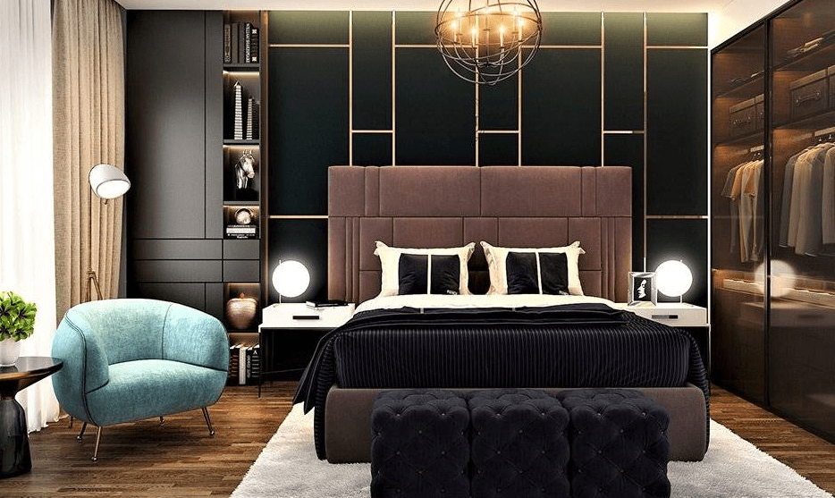 Dramatic eclectic bedroom with tall upholstered headboard, dark paneled accent wall with gold lines, teal armchair, tufted bench, and glass wardrobe with clothes on display